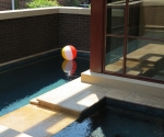 View of the pool and hottub agaist the stairwell window tower