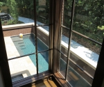 view of the stair window with the pool in the background